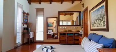 a living room with a blue couch and a mirror at Coming Home in Centurion