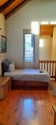 a large bed in a room with a window at Coming Home in Centurion