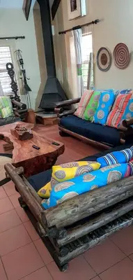 a room with two couches and a table with pillows at UrbanEscape in Centurion