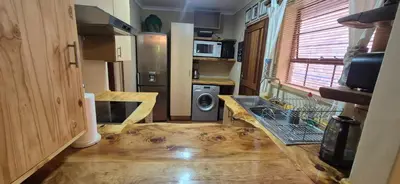 a kitchen with a washer and dryer in a tiny house at UrbanEscape in Centurion