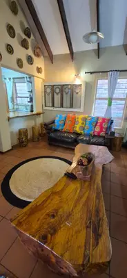 a living room with two couches and a wooden table at UrbanEscape in Centurion
