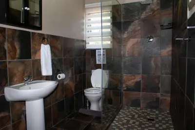a bathroom with a toilet and a sink at Casa de la Presa 6 in Polokwane