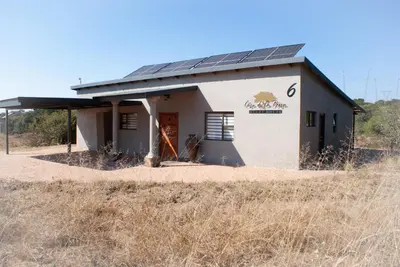 a building with solar panels on it in a field at Casa de la Presa 6 in Polokwane