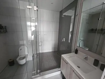 a bathroom with a shower and a toilet and a sink at Capital Trilogy Apartments in Pretoria