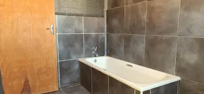 a bathroom with a sink and a shower at Henning nest guest house in Centurion