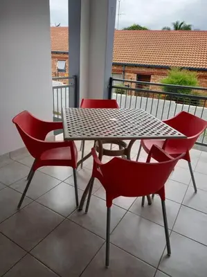 a table and chairs sitting on a balcony at NO loadshedding 3km to Gautrain Short or Long stays Uncapped Wi-Fi in Centurion