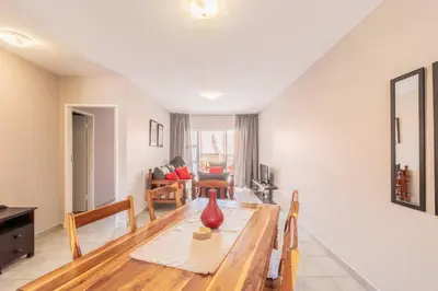 a living room with a table with a red vase on it at NO loadshedding 3km to Gautrain Short or Long stays Uncapped Wi-Fi in Centurion
