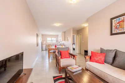 a living room with a couch and a table at NO loadshedding 3km to Gautrain Short or Long stays Uncapped Wi-Fi in Centurion