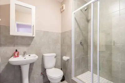 a bathroom with a toilet and a sink and a shower at NO loadshedding 3km to Gautrain Short or Long stays Uncapped Wi-Fi in Centurion