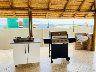 a kitchen with a stove and a grill and a counter at Muzee Wethu Accommodations in Armburg