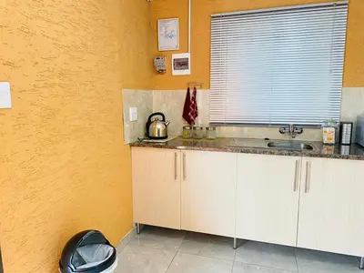 a kitchen with a counter and a sink and a window at Muzee Wethu Accommodations in Armburg