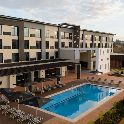 an aerial view of a hotel with a pool and chairs at Premier Hotel Thohoyandou in Thohoyandou