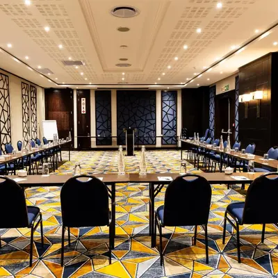 a large room with tables and chairs in it at Premier Hotel Thohoyandou in Thohoyandou