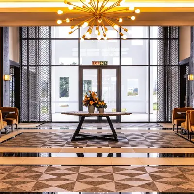 a lobby with a table and a large window at Premier Hotel Thohoyandou in Thohoyandou