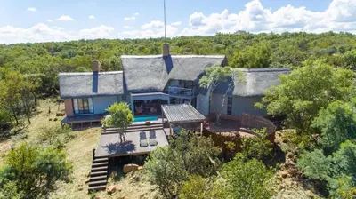 an aerial view of a house in the woods at Serengeti Lodge Mabalingwe in Mabula