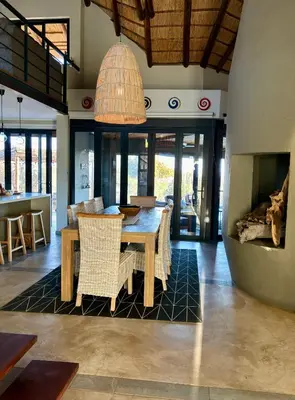 a dining room with a table and chairs at Serengeti Lodge Mabalingwe in Mabula
