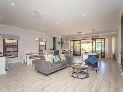 a living room with a couch and a table at Golf & Leisure Delight - Pecanwood Golf Estate - Hartbeespoort in Hartbeespoort