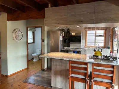 a kitchen with a large island in the middle at Cozy Wood Retreat in Centurion