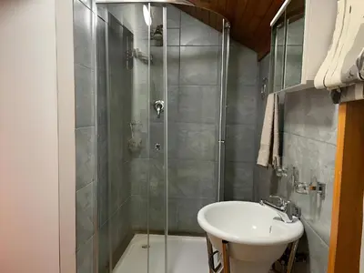 a bathroom with a shower and a sink at Cozy Wood Retreat in Centurion