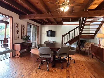 a dining room with a table and chairs at Cozy Wood Retreat in Centurion