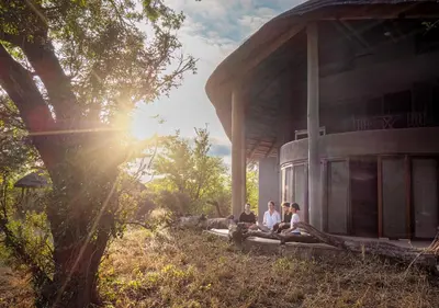 a group of people sitting outside of a building at Motswari African Retreat & Walking Safaris by NEWMARK in Timbavati Game Reserve