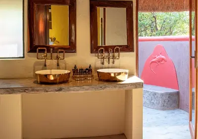 a bathroom with two sinks on a counter at Motswari African Retreat & Walking Safaris by NEWMARK in Timbavati Game Reserve