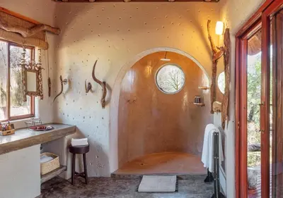 a bathroom with a shower with a sink at Motswari African Retreat & Walking Safaris by NEWMARK in Timbavati Game Reserve