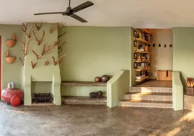 a living room with a ceiling fan and a staircase at Motswari African Retreat & Walking Safaris by NEWMARK in Timbavati Game Reserve