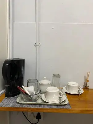a table with plates and cups and a coffee maker at Divine Sleep in Bela-Bela