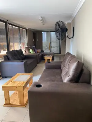 a living room with couches and a coffee table at Divine Sleep in Bela-Bela