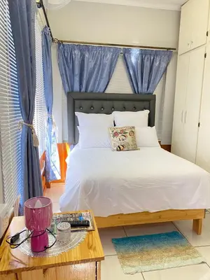a bedroom with a bed and a coffee table at Divine Sleep in Bela-Bela