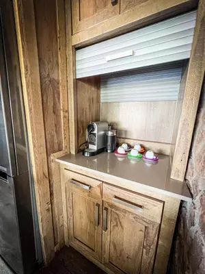 a kitchen with a counter with a microwave and a refrigerator at 22 Siyanda Mabalingwe in Mabula