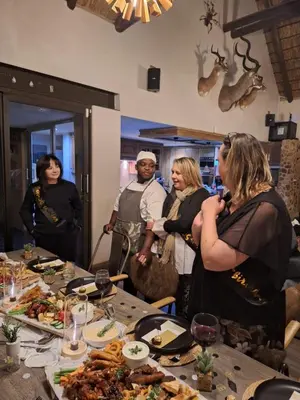 a group of people standing around a table with food at 22 Siyanda Mabalingwe in Mabula
