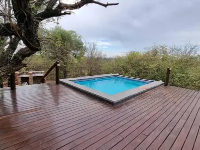 a swimming pool on top of a wooden deck at 22 Siyanda Mabalingwe in Mabula