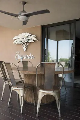 a dining room with a table and two chairs at 22 Siyanda Mabalingwe in Mabula