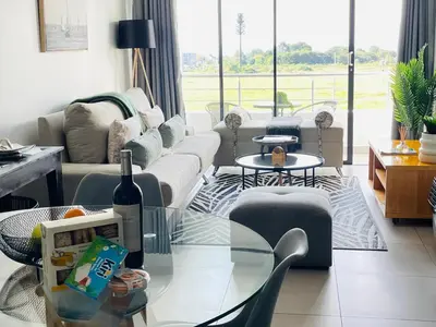 a living room with a couch and a glass table at 2Bedroom Luxury Family Living Space in Midrand in Midrand