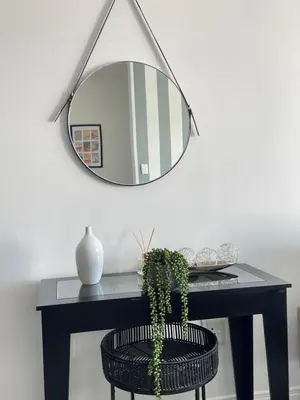 a mirror above a table with a plant on it at 2Bedroom Luxury Family Living Space in Midrand in Midrand