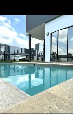a large swimming pool in front of a building at 2Bedroom Luxury Family Living Space in Midrand in Midrand