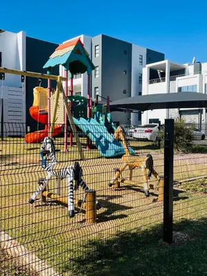a playground with two play equipment in a park at 2Bedroom Luxury Family Living Space in Midrand in Midrand