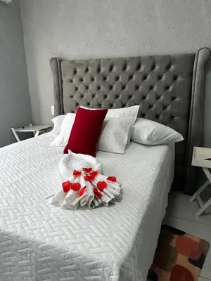 a bed with red and white flowers on it at RANTI Guest House in Ga-Mothiba