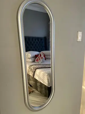 a mirror reflection of a bed in a bedroom at RANTI Guest House in Ga-Mothiba