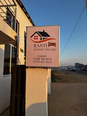 a sign for a guest house on the side of a building at RANTI Guest House in Ga-Mothiba