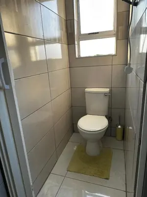 a small bathroom with a toilet and a window at RANTI Guest House in Ga-Mothiba