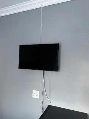 a flat screen tv hanging from a wall at RANTI Guest House in Ga-Mothiba