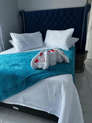 a bed with two towels sitting on top of it at RANTI Guest House in Ga-Mothiba
