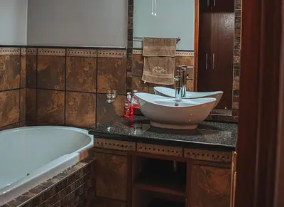 a bathroom with a sink and a bath tub at 848 at Highland Gate by Euphoric Leisure in Dullstroom