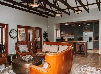 a living room with a couch and chairs and a table at 848 at Highland Gate by Euphoric Leisure in Dullstroom