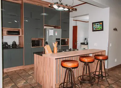a kitchen with a counter with stools at a bar at 848 at Highland Gate by Euphoric Leisure in Dullstroom