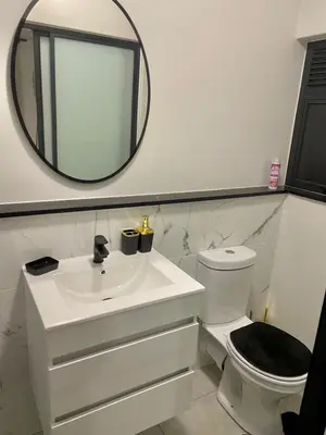 a white bathroom with a sink and a mirror at Waterfall Paradise Entire Executive 1 Bed Apt in Midrand