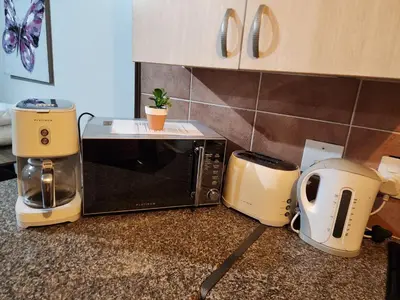 a kitchen counter with a microwave and a toaster at Lions Haven in Pretoria